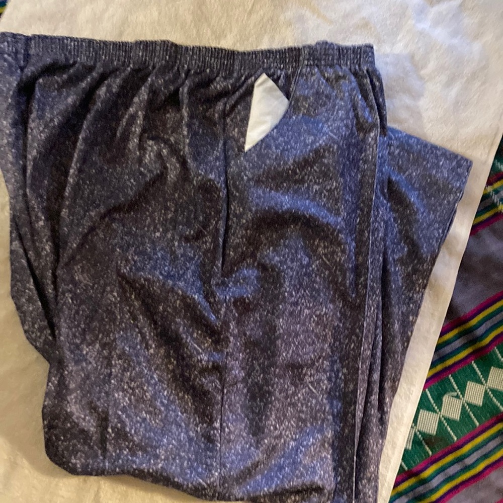 Pants with stretch waistband and sewn seam down front. Side pockets.